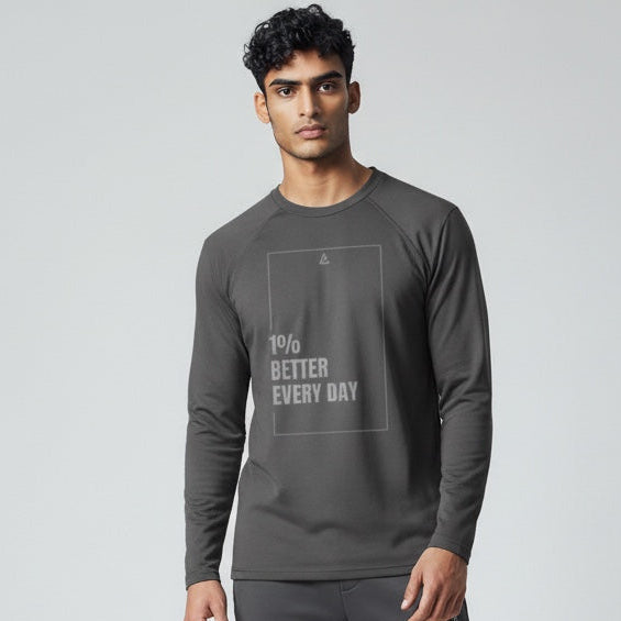 Man wearing a dark gray tracksuit with motivational text on a light gray background