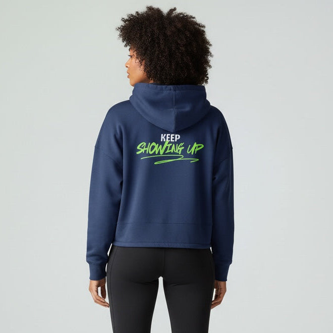 Person wearing a blue hoodie with text on the back, standing against a white background