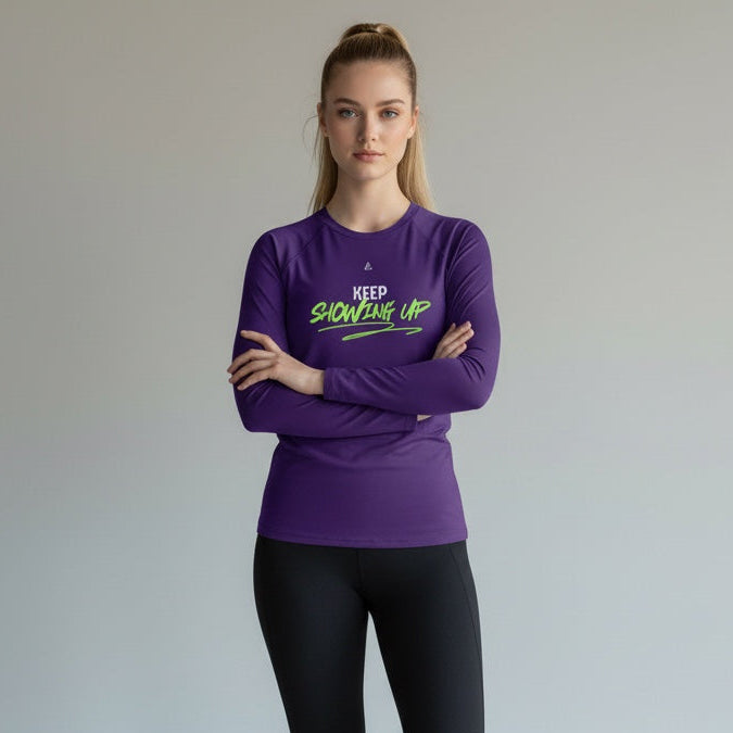 Woman wearing a purple long-sleeve shirt and black leggings with text on a plain background