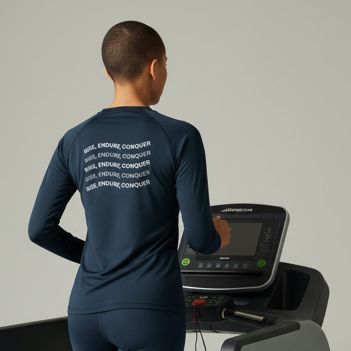 Person using a treadmill wearing a navy blue athletic outfit with text on the back.