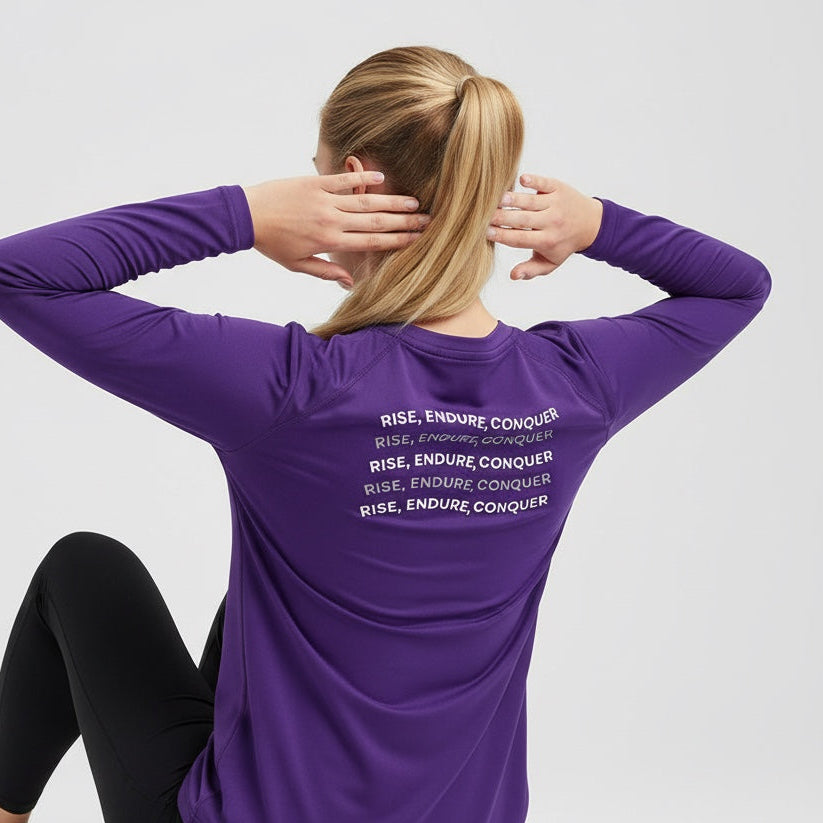 Person wearing a purple long-sleeve shirt with text on the back, sitting against a white background